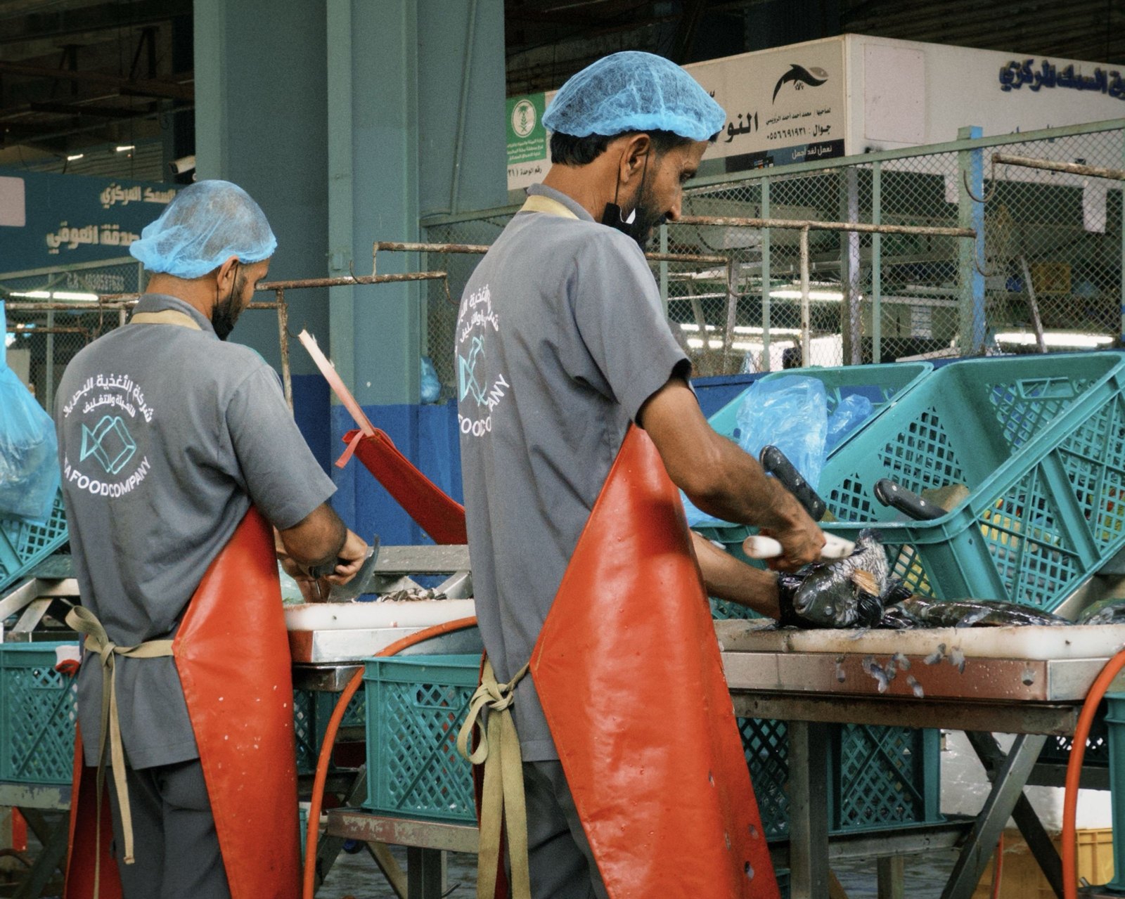 Workers preparing fish at a Gulf fish market: preparation and hygiene are central to Halal assessments of seafood. Illustrative photo: Unsplash.